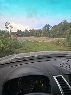 Estacionamento grande, com gramado ao lado